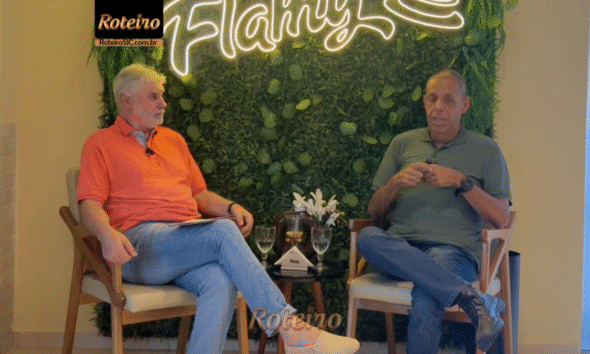 Glauco Guimarães e apresentador do RoteiroSJC, Marcio Marcondes, em entrevista descontraída na Flamy São José dos Campos. O locutor veste camisa escura e sorri durante o bate-papo sobre sua trajetória no rádio.