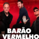 Quatro integrantes do Barão Vermelho posam para foto promocional com fundo vermelho intenso. Os músicos vestem roupas escuras e aparecem em poses expressivas. Na parte inferior da imagem, o nome da banda em letras brancas grandes: "Barão Vermelho". No canto inferior direito, a marca d'água do Portal RoteiroSJC.