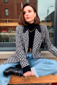 Mulher com blazer pied-de-poule preto e branco, gola rolê e jeans — estampas clássicas do inverno 2026 SJC