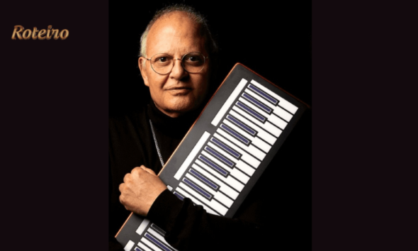 Guilherme Arantes segurando teclado portátil em foto de divulgação da turnê 50 Anos Luz em SJC