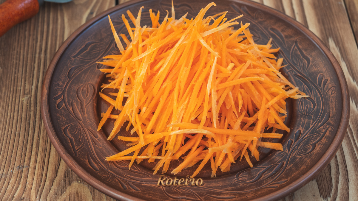 Corte julienne de cenoura em tiras finas sobre tábua de madeira — técnica culinária ensinada pelo Portal RoteiroSJC
